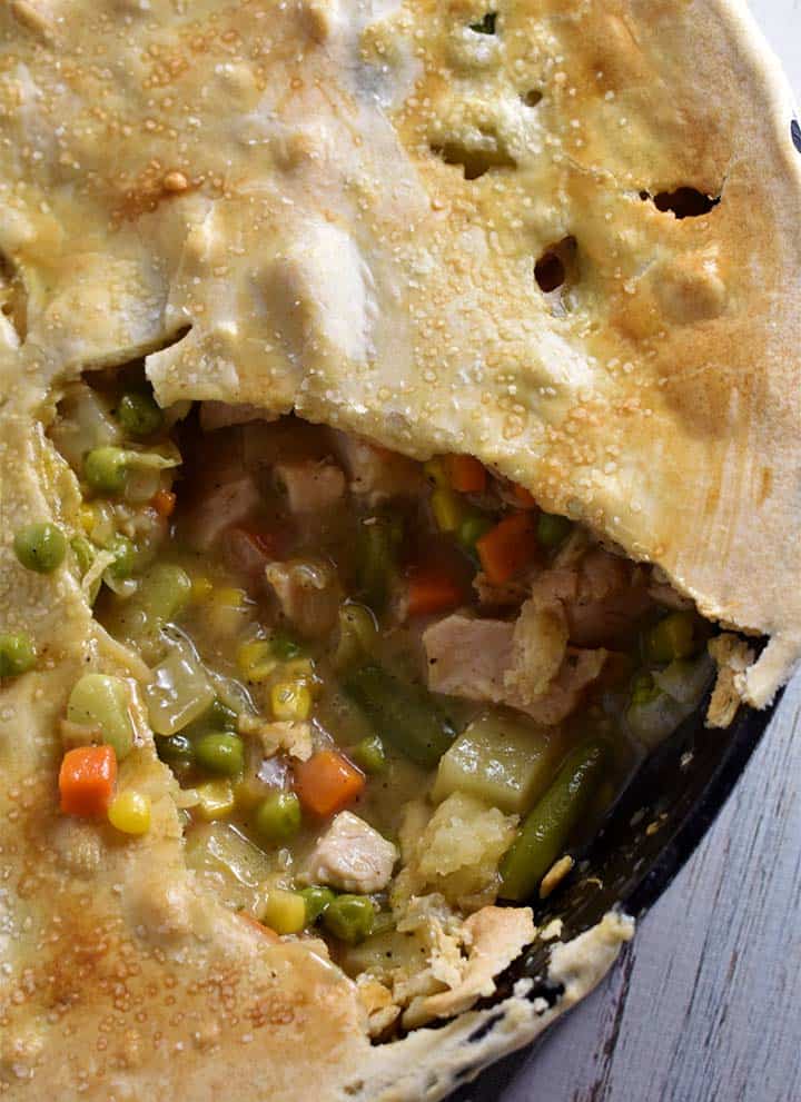 Turkey Pot Pie in a cast iron pan with slice cut out