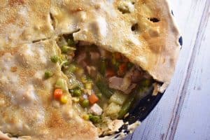 Turkey Pot Pie with slice removed horizontal in cast iron pan