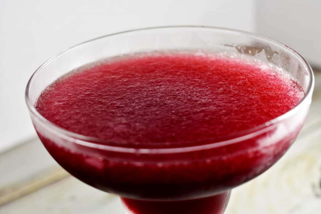 close up of pomegranate margarita in margarita glass