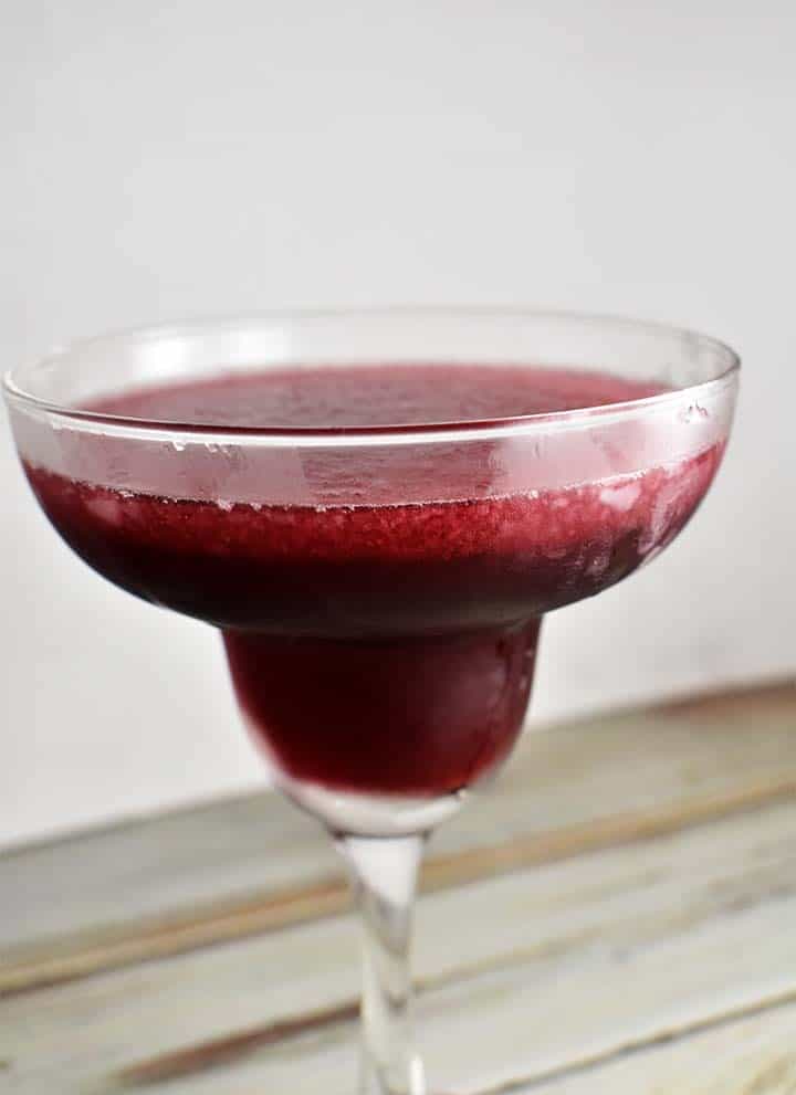 pomegranate margaritas in glass on white background