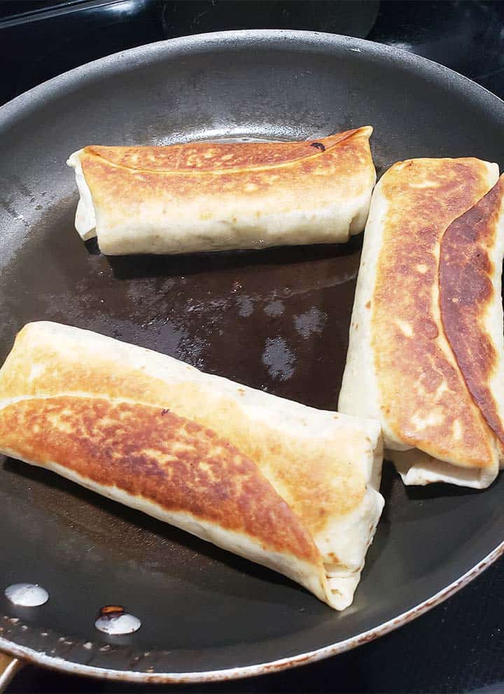 chimichangas in a shallow pan fry