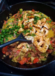 shrimp and grits toppings in cast iron pan