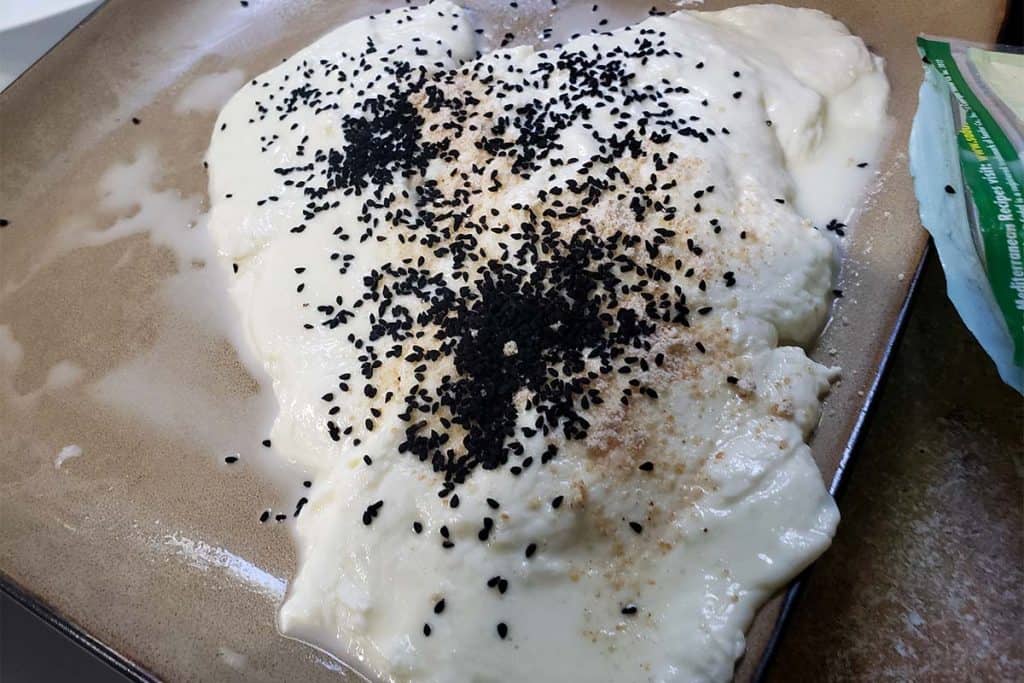 raw curd mozzarella with middle eastern spices on a plate