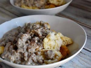 biscuits and gravy in a white bowl on a white table