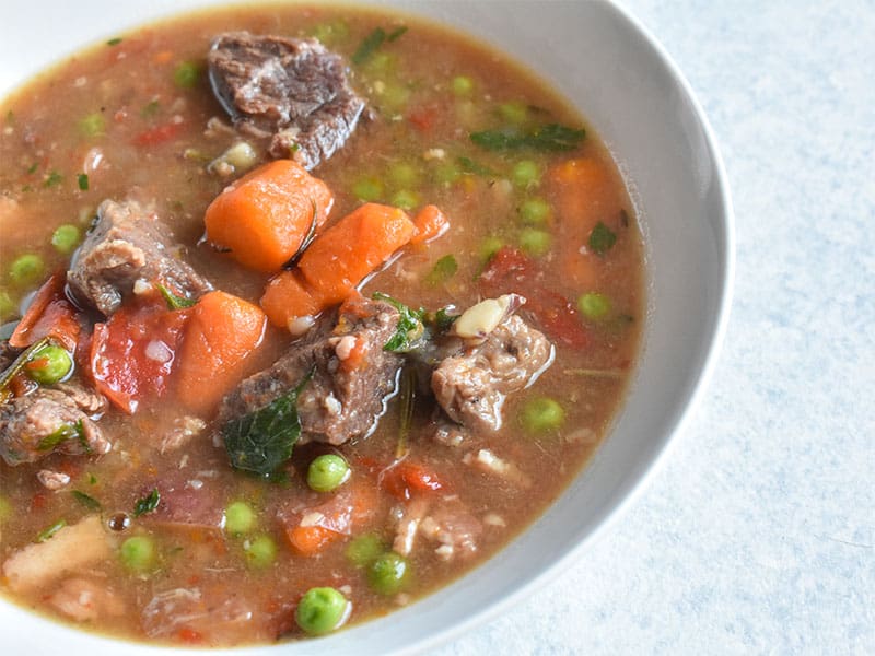 Instant Pot Beef Stew in a white bowl on a white table