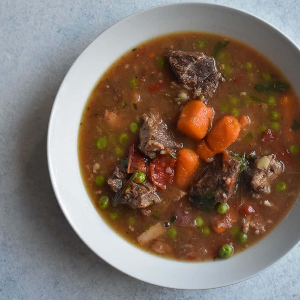 stew in white bowl on white table