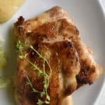 sous vide chicken thighs on a white plate - for pinterest