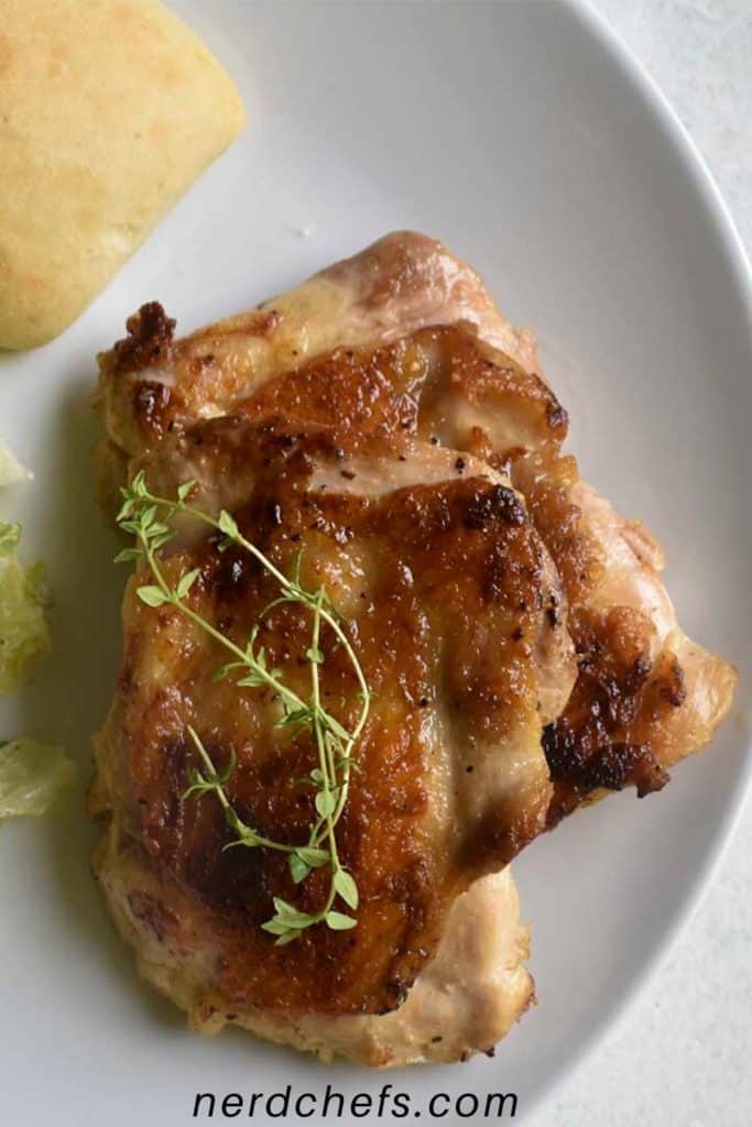 sous vide chicken thighs on a white plate - for pinterest