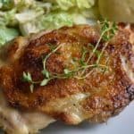 sous vide chicken thighs on a white plate - for pinterest