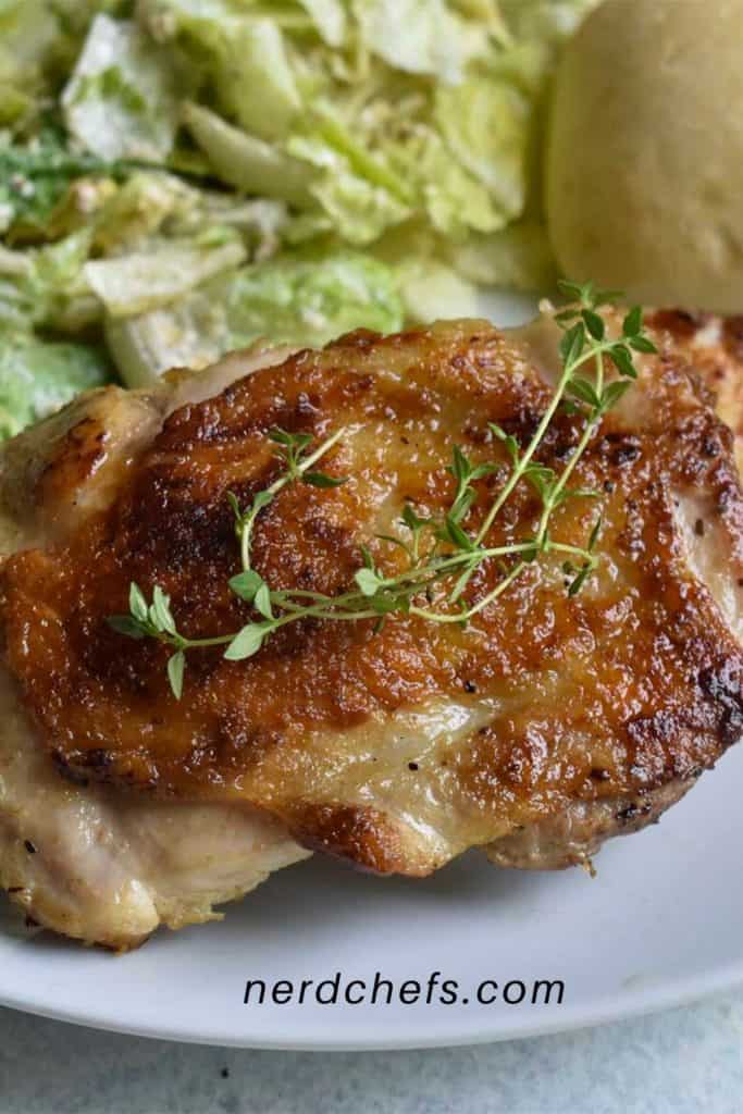 sous vide chicken thighs on a white plate - for pinterest