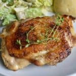 sous vide chicken thighs on a white plate - for pinterest