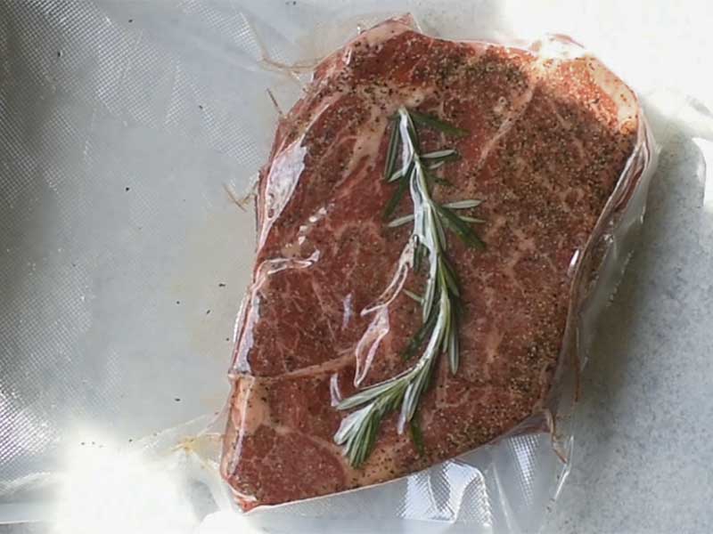 chuck roast and rosemary in a vacuum sealer bag