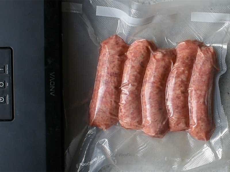 sausage sealed tightly in a vacuum sealer bag with an anova vacuum sealer