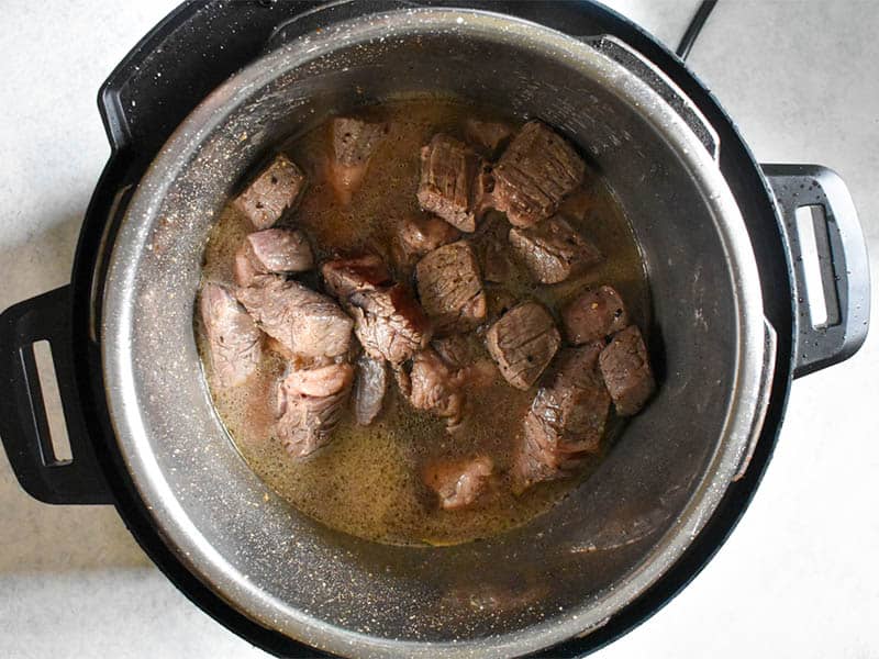 beef chunks and beef stock in an instant pot