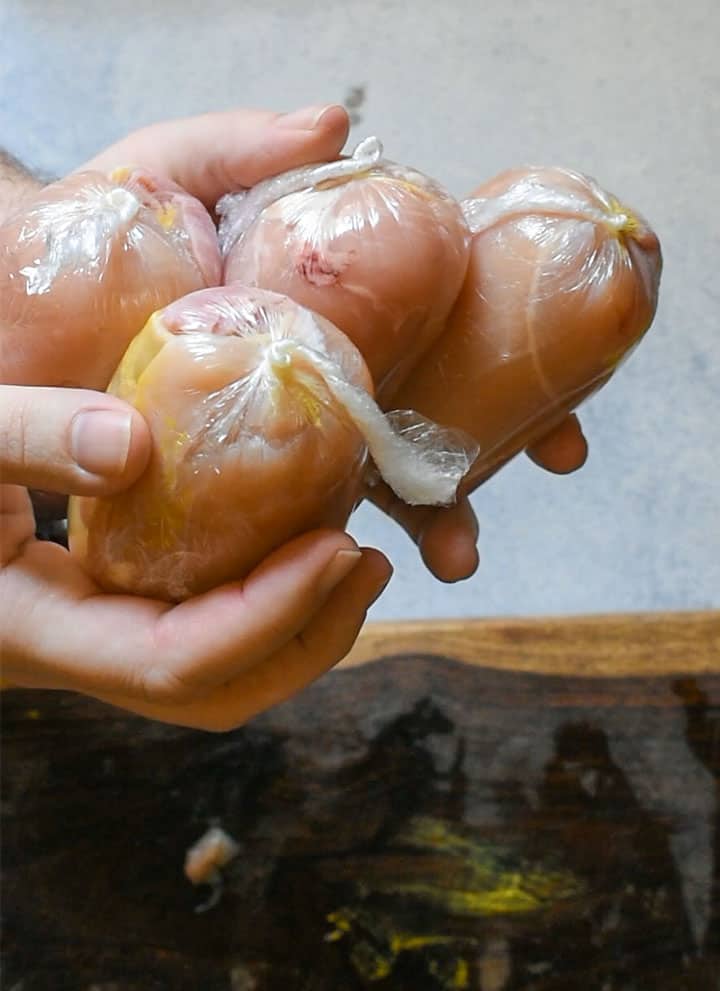 chicken wrapped into tight balls using cling wrap.