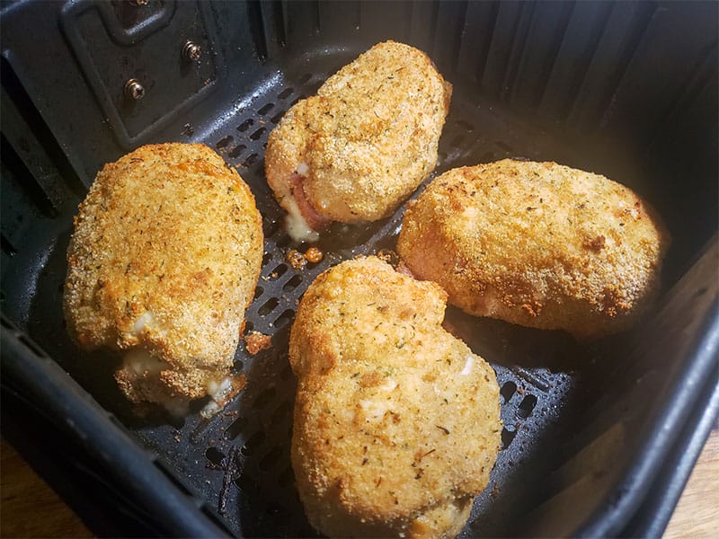 cooked chicken cordon bleu in an air fryer basket